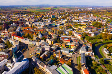 Obraz premium Panoramic aerial view of autumn scape of Czech city of Opava on bank of small river on sunny day, Moravian-Silesian Region