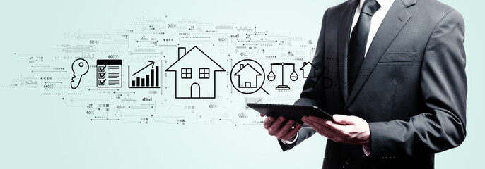 Real estate theme with businessman holding a tablet computer