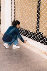 young girl closing business gate with key as end of her business