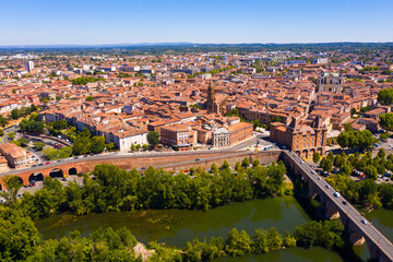 Fototapeta na wymiar Panoramic view from drone of houses and bridges over Tarn river of french city Montauban