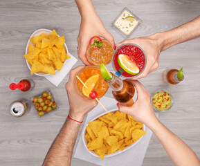 top view of hands celebrating with drinks