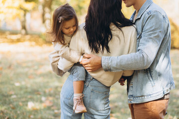 Fototapeta premium Happy young family spending time together in autumn park
