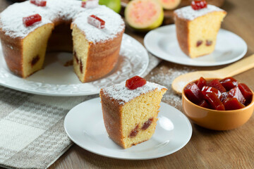 Brazilian corn cake made with a type of corn flour (Fuba) filled with guava paste. On a wooden party table. Typical sweets of the June festival. Cornmeal cake