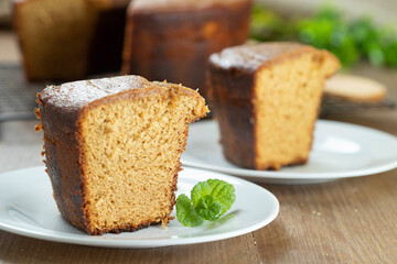 Close up piece of Brazilian corn cake made with a type of corn flour (Fuba). On a wooden party table. Typical sweets of the June festival. Cornmeal cake
