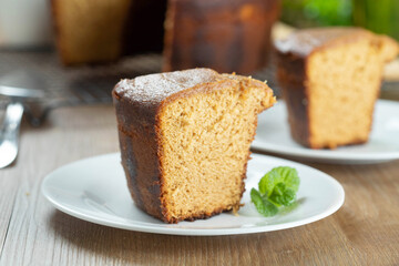 Close up piece of Brazilian corn cake made with a type of corn flour (Fuba). On a wooden party table. Typical sweets of the June festival. Cornmeal cake