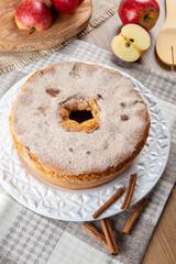 Sponge cake or chiffon cake with apples so soft and delicious sliced ​​with ingredients: cinnamon, eggs, flour, apples on wooden table. Home bakery concept for background and wallpaper. Top view.