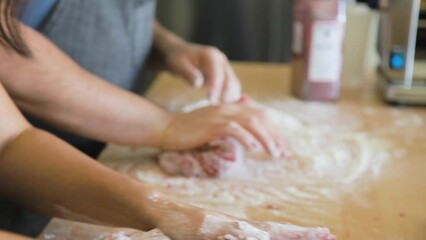 Couple kneads flour into pasta dough for couple's cooking class