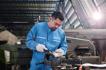 One professional Asian male industry engineer worker works in a safety uniform with metalwork...