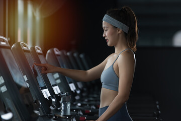 woman in a gym. woman in a gym. person in a gym. Sportswoman or athlete smiling on training while running on treadmill machine in the gym. Happy and positive people workout.