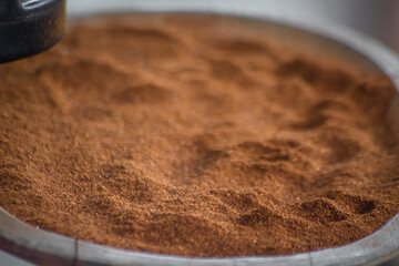 Background of freshly ground roasted coffee in bowl