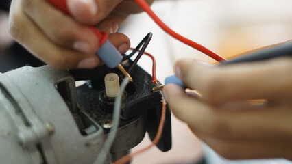 Electrical appliance, Electrician, The technician is repairing the electrical appliances in the house to return them to normal operation.