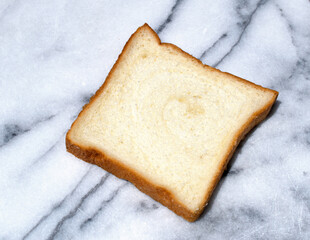 White piece of bread on marble 