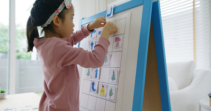 Little cute girl happy play and learn offline class computer language on board game Unplugged Coding computing concept for asia people kindergarten gen Z smart kids at home. STEM STEAM ICT skill.