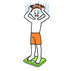 体重計に乗ってショックを受けている男性