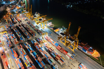 Time lapse view of container cargo ship in the export, import business, logistics and transportation. International goods in urban city. Shipping to the harbor by crane in Bangkok City, Thailand
