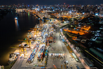 Fototapeta na wymiar Time lapse view of container cargo ship in the export, import business, logistics and transportation. International goods in urban city. Shipping to the harbor by crane in Bangkok City, Thailand 