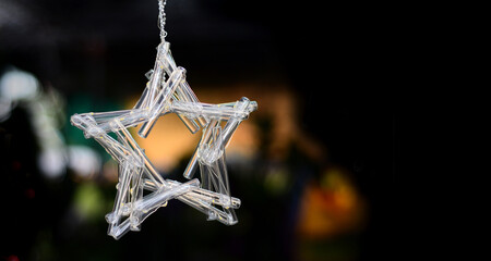 star shape light decoration, on black background, made from many short glass tubes, free space on rigth.