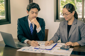 Two business leaders talk about charts, financial graphs showing results are analyzing and calculating planning strategies, business success building processes