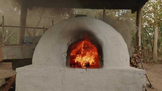 Wood-fired oven burning in slow motion, waiting for it to reach the optimum temperature for baking bread, Honduras.