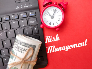 Wireless keyboard,clock and banknotes with the word Risk Management.