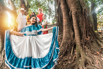 Nicaraguan teenagers with typical costume of Latin American culture smiling and looking at the camera in a forest