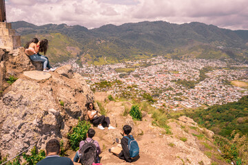 Young students from Nicaragua enjoying a moment of recreation on top of a mountain with the city of Jinotega in the background