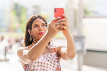 Transsexual woman taking a selfie outdoors. Close up