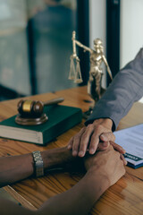 Attorney-consultants hand in hand to offer comforting advice to clients after consulting and providing details about the lawsuit. and defend the case that has been fully accepted lawyer concept