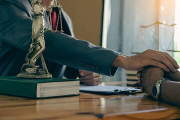 Attorney-consultants hand in hand to offer comforting advice to clients after consulting and providing details about the lawsuit. and defend the case that has been fully accepted lawyer concept