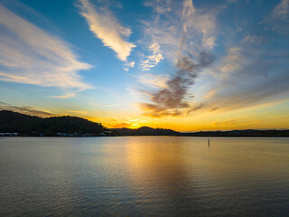 Fototapeta na wymiar High cloud sunrise at the waterfront