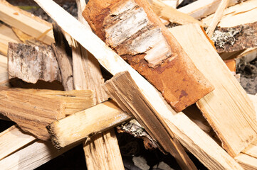 A pile of chopped firewood, dumped in disorder on the lawn