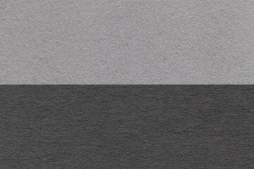 Texture of craft gray and black paper background, half two colors, macro. Structure of vintage...
