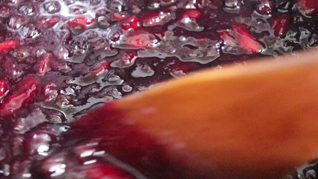 Making homemade jam : Boil the aronia, peach, sugar and lemon juice. Aronia is a superfood, also called chokeberry or king's berry.