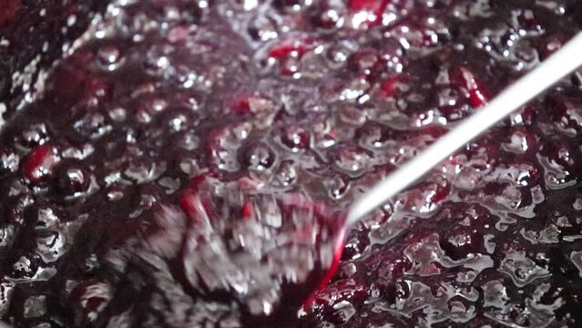 Making homemade jam : Boil the aronia, peach, sugar and lemon juice. Aronia is a superfood, also called chokeberry or king's berry.