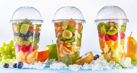 Plastic cups filled with ripe fruit salad