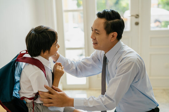 Father teasing his son before going to school