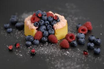 Cake with cream covered with juicy berries.