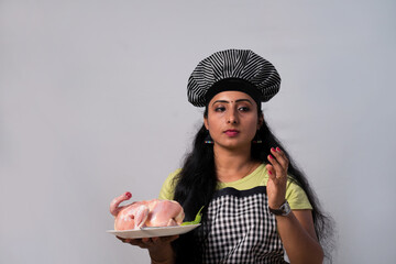 Traditional and  Professional cook,  Woman professional chef hold dressed chicken ready to cook  
