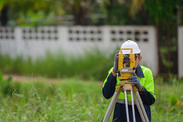 Male civil engineer surveying with theodolite apparatus Before construction on the construction...