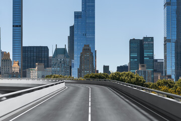 Empty urban asphalt road exterior with city buildings background. New modern highway concrete construction. Concept of way to success. Transportation logistic industry fast delivery. New York. USA.