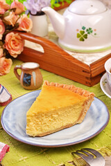 A slice of delicious cheese pie served on table  