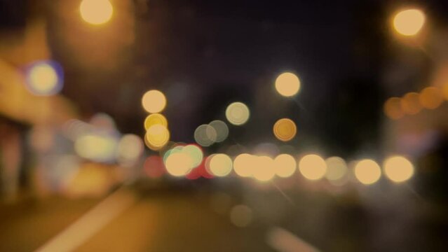Bokeh light on  night city. Round colorful bokeh shines from heavy traffic from car headlights on a city street.