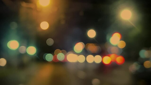 Beautiful glitter,sparkling defocus light  night city. Round colorful bokeh shines from heavy traffic from car headlights on a city street.