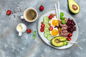 Keto breakfast with avocado, fried eggs, bacon, and beans. paleo keto breakfast diet lunch. Healthy nutritious paleo keto breakfast concept. place for text, top view