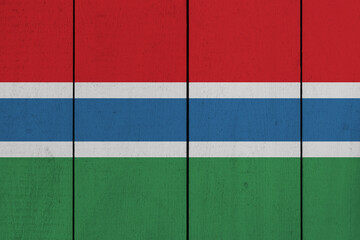 Patriotic wooden plank background in colors of flag. Gambia