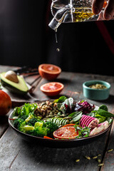 vegetable vegetarian buddha bowl avocado, blood orange, broccoli, watermelon radish, spinach,...