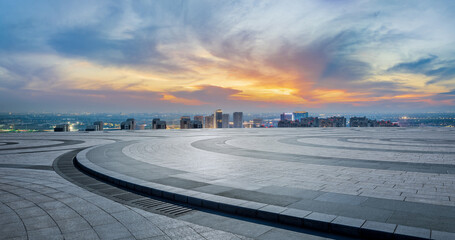 Empty floor and modern city skyline with building scenery at sunset. high angle view.