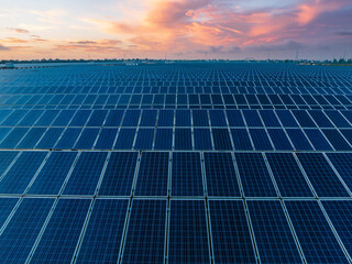 Aerial view of solar power station at beautiful sunset. solar photovoltaic power station on water....