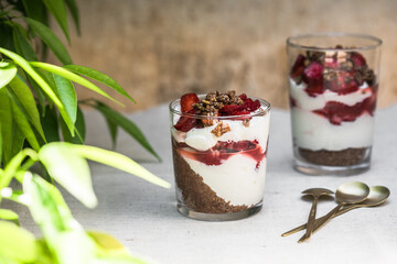 Breakfast layered parfait dessert with yogurt, sponge biscuit and fresh strawberry, white background copy space