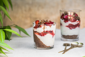 Breakfast layered parfait dessert with yogurt, sponge biscuit and fresh strawberry, white background copy space